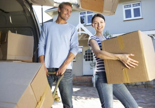 couple packing moving truck